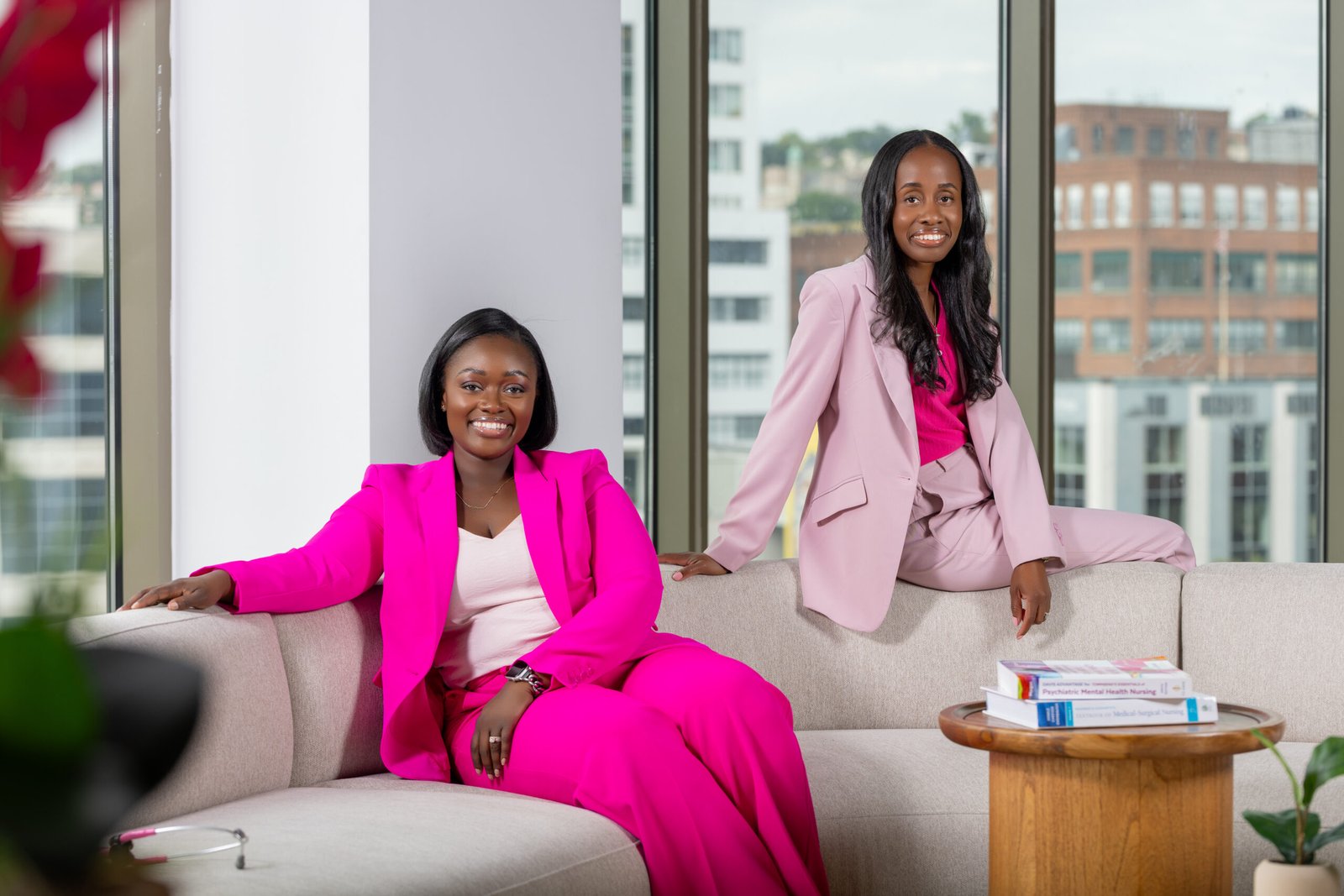 Founders of Sister’s Nursing, an online nursing education company, in pink suits for a personal branding portrait in a modern office